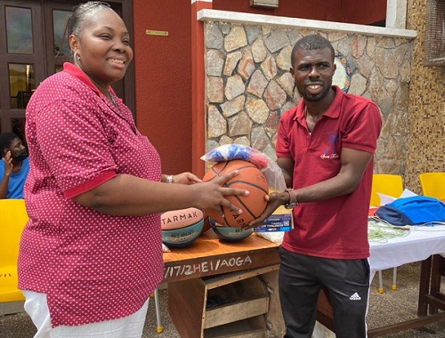 Madam Aurora Commodore-Toppar presenting the items to Hadad Bempah, head of physical education at the school