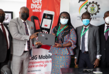 Mr Emmanuel Nikoi of CBG (2nd left) presenting one of the laptops to Prof Rita Akosua Dickson (3rd right) while officials of both institutions look on - Copy