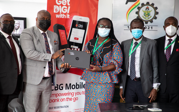 Mr Emmanuel Nikoi of CBG (2nd left) presenting one of the laptops to Prof Rita Akosua Dickson (3rd right) while officials of both institutions look on - Copy