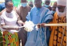 Inset; Vice President, Dr Bawumia (middle) being assisted by other dignitaries to cut the tape to open the building