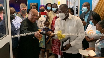 Mr Lord Paul Boateng(left) cutting the tape to commission the facility