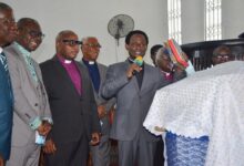 Apostle Prof. Opoku Onyinah (with the two Bibles) doing the dedication ceremony, with him are other clergy. Photo. Vincent Dzatse