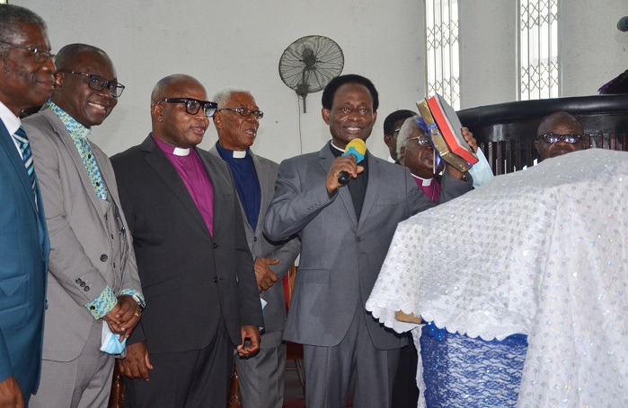 Apostle Prof. Opoku Onyinah (with the two Bibles) doing the dedication ceremony, with him are other clergy. Photo. Vincent Dzatse