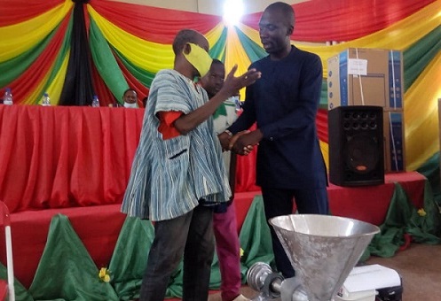 Mr Benjamin Yaw Gyarko (left) presenting items to one of the beneficairies