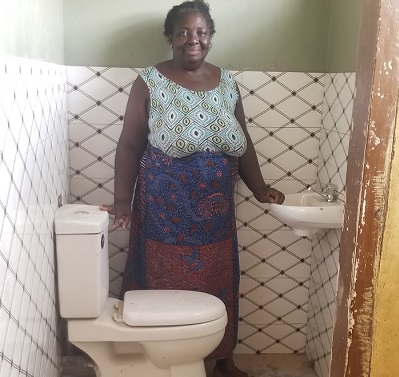 A beneficiary in one of the bio-digester toilets
