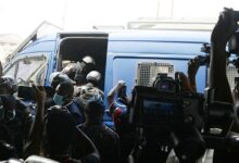 Police shoving Barker-Vormawor into the van