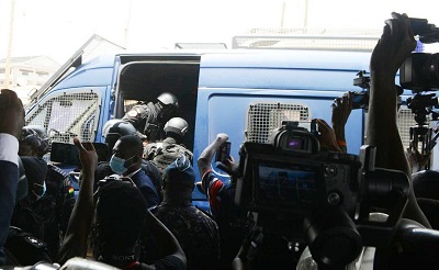 Police shoving Barker-Vormawor into the van