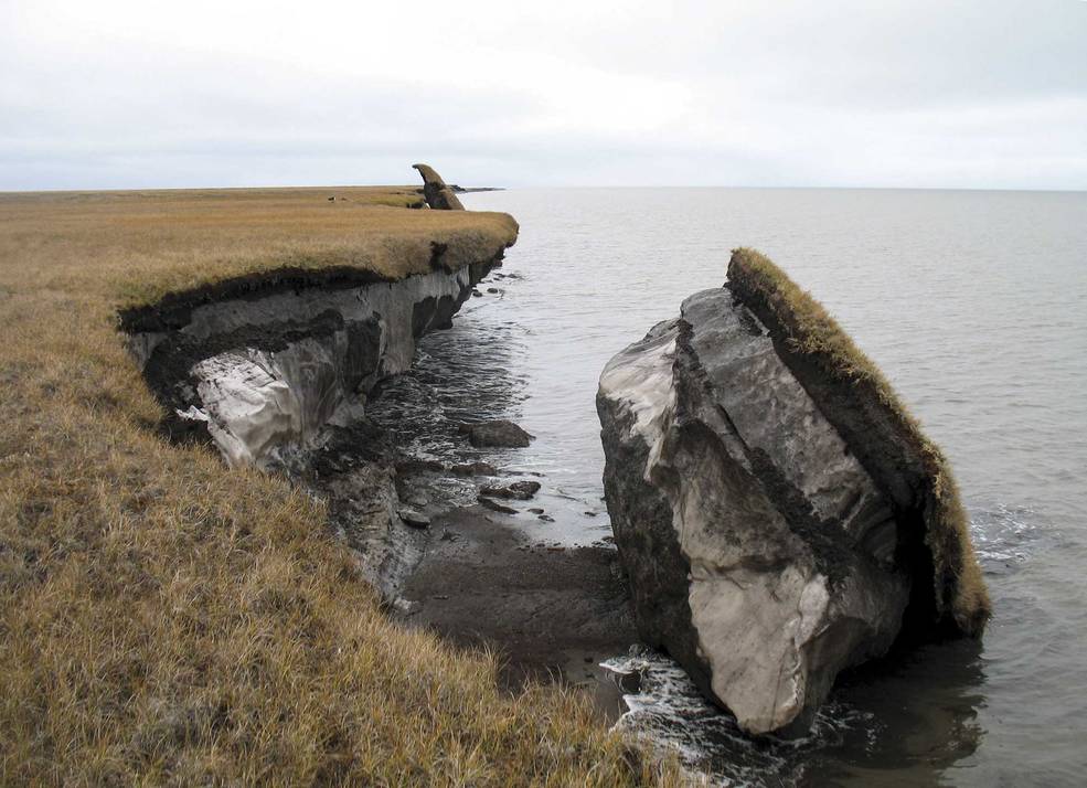 Thawing permafrost can result in the loss of terrain, as seen in this image where part of the coastal bluff along Drew Point, Alaska, has collapsed into the ocean. Credits: Benjamin Jones, USGS