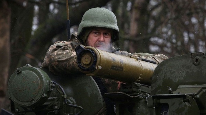 Ukrainian soldier stands guard close to the front line with Russian troops near Kharkiv