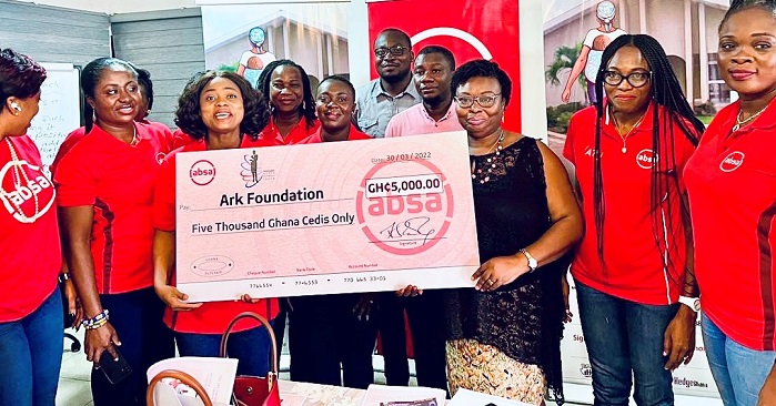 Absa Bank officials presenting a dummy cheque to Ark Foundatin Official