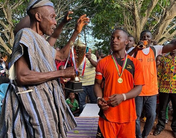 • Captain of the Ghana team Boukari Dakpo (left) ready to receive the trophy from the Dzutor of Alawogbe, Togbe Yaovi Helu