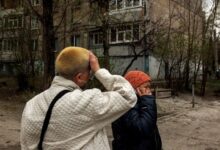 Two Kharkiv residents react after a fresh wave of Russian shelling targeted the city