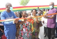 Inset.Mrs Owusu-Ekuful(second from right) and Mr Bray(right)cutting the tape to commission the classroom block,With them are other dignitaries Photo Anita Nyarko-Yirenkyi