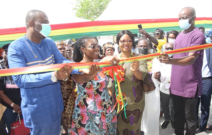 Inset.Mrs Owusu-Ekuful(second from right) and Mr Bray(right)cutting the tape to commission the classroom block,With them are other dignitaries Photo Anita Nyarko-Yirenkyi