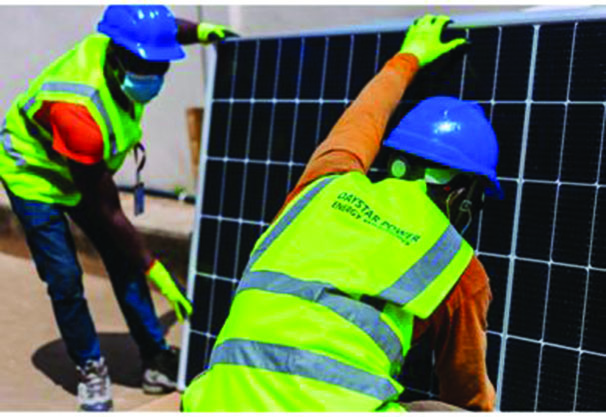 • Workers installing a solar panel