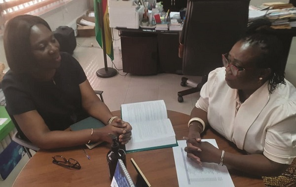 Mrs Adusei-Poku (right) in a discussion with an official of the Office of Public Prosecution