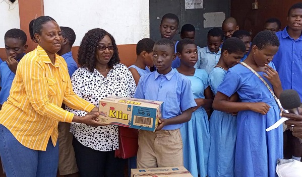 Ms Gbeblewu (right) presenting the items to an inmate of the school