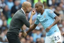 Guardiola (left) giving instructions to Fernandinho during a league game