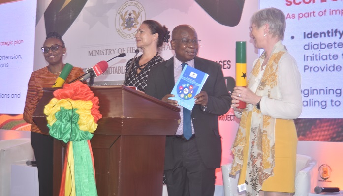 Mr Kwaku Agyeman-Manu (second from right) being assisted by Dr Matsihidiso R. Moeti, (left) Bente Mikkelsen(right) and Ingrid Mollestad to launch the policy