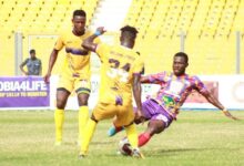 Medeama's Darlington Appiah (centre) challenges Hearts’ Isaac Agyenim Boateng during yesterday's encounter