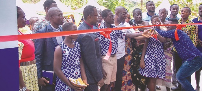 Inset; Mr Oppong Nkrumah cutting the tape to inaugurate the school building