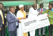 Dr. Owusu Afriyie Akoto (right) presenting the dummy cheque to Alhaji Mohammed Mashud (third from right).With them include Dr John Kofi Mensah (second from left),MD,ADB. Photo. Ebo Gorman