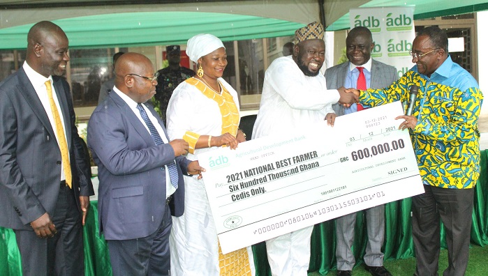 Dr. Owusu Afriyie Akoto (right) presenting the dummy cheque to Alhaji Mohammed Mashud (third from right).With them include Dr John Kofi Mensah (second from left),MD,ADB. Photo. Ebo Gorman