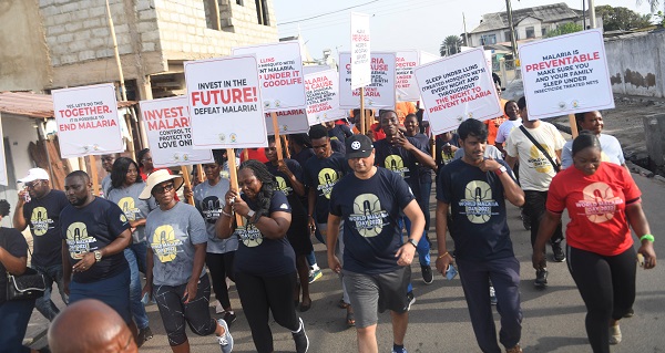 Healthwalk----Some of the participants with placards matching on the street.Photo Geoffrey Buta