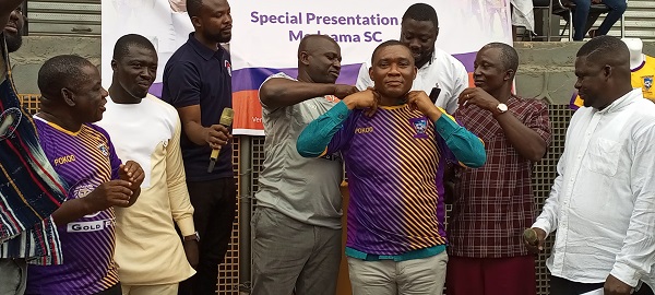 Mr Armah assist Mr Duker to wear a customized Medeama jersey after the presentation