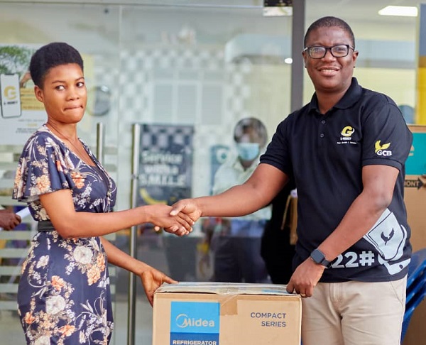 One of the G-Money promotion winners (left) receiving her prize