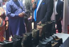 Dr Karl Laryea explaining to Vice President, Dr Mahammudu Bawumia about the shoes
