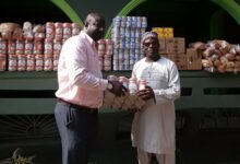 Dr Kissi (right) presenting the items to Mr Abdullah