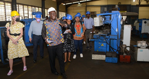 Mr Quansah (infront) General Manager Engineering, conducting the visitors round the mechanical workshop