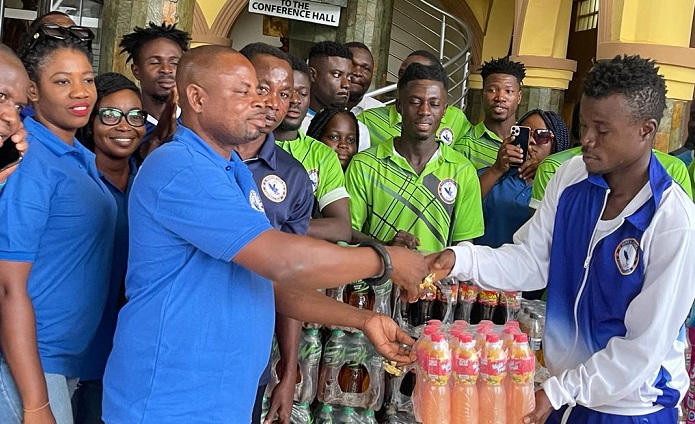 Chelsea captain Jackson Owusu (left) receiving the donation from Nana Gyimah on Friday