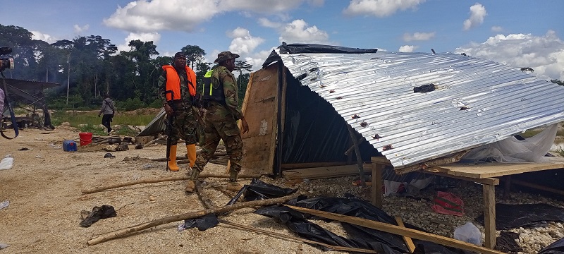 Soldiers of Operation Halt II destroying a makeshift house at the site