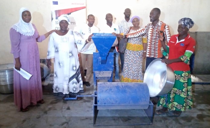 Ms Ward-Brew (right) handing over the equipment to the leader of Billaw Women group