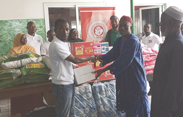 Imam Seth (left) presenting the items to Mallam Musah. Looking on are members of the GAMP