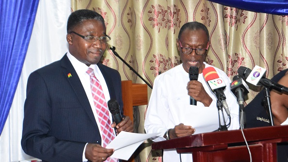 Prof Robert Kingsford Adaboh (left) swearing Prof. Bosu into office