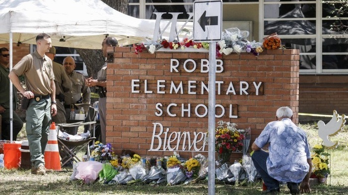 People have been laying flowers near the school campus in Uvalde as tributes