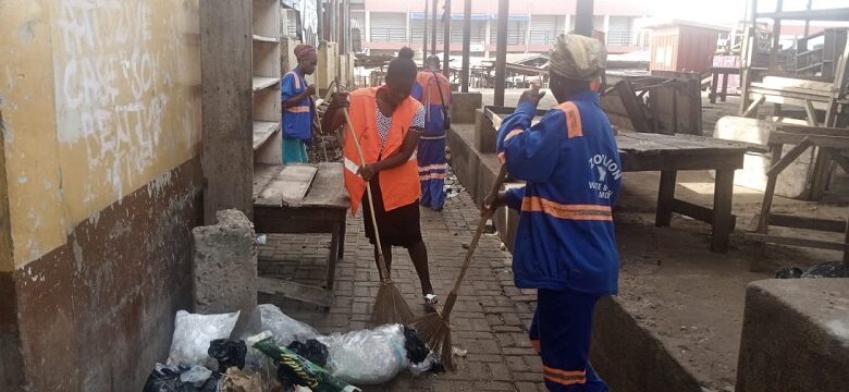 Some Zoomlion workers busily sweeping the Ho market