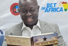 Sports-Writers-Association-of-Ghana-SWAG-President-Kwabena-Yeboah-with-a-copy-of-the-book