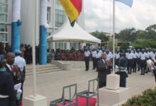 Mr Thomas Mbomba (left) and Mr Charles Abani hoisting Ghana and UN flags respectively to mark the day. Photo Godwin Ofosu-Acheampong