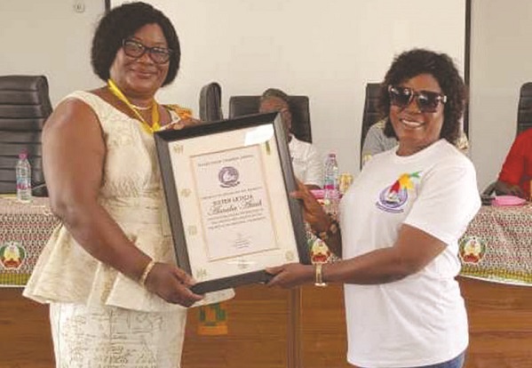 Ms Larsen (left) presenting an award to Mrs Leticia AsaabaAtiah, Greater Accra Regional chairperson, NARM