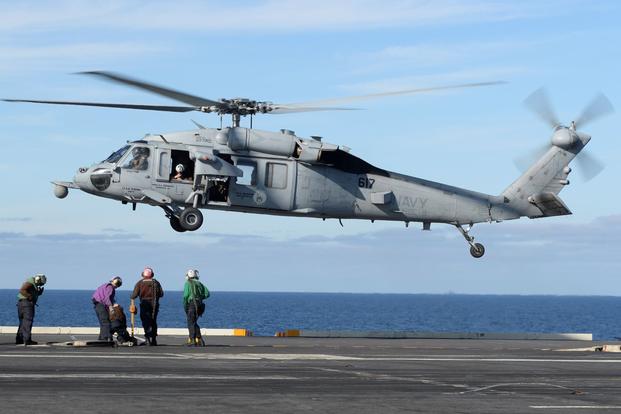 An MH-60S Sea Hawk helicopter, from the "Eightballers" of Helicopter Sea Combat Squadron (HSC) 8, prepares to land on the flight deck of the aircraft carrier USS Nimitz (CVN 68) on March 19, 2017. (Ian Kinkead/U.S. Navy)