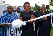 Ms Pearl (middle) cutting the ribbon to inaugurate the agency office at Accra Technical University, while other officials look on