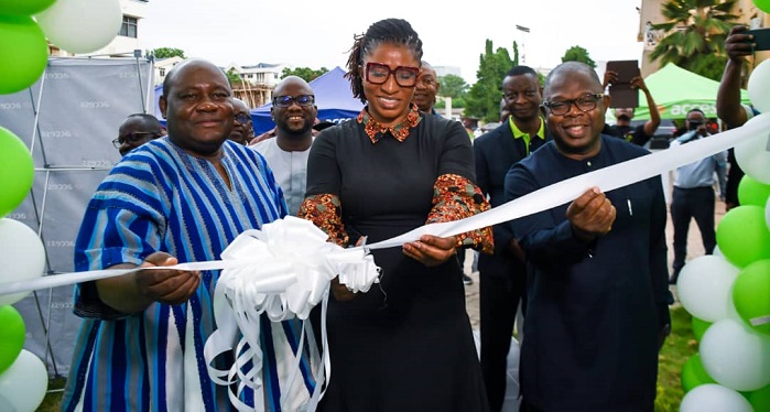 Ms Pearl (middle) cutting the ribbon to inaugurate the agency office at Accra Technical University, while other officials look on