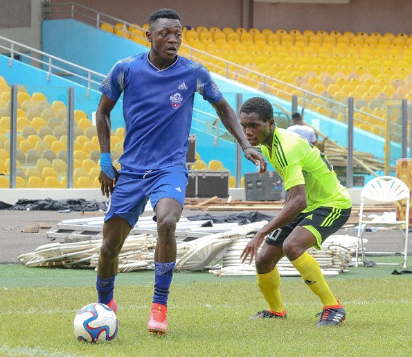 Leonard Abrowkah controls the ball ahead of Samuel Ankrah of New Town Youth FC
