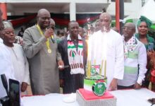 Alhaji Muntaka (fifth from right), Dr Sarpong (microphone in hand)and other executives of the party about to cut the anniversary cake