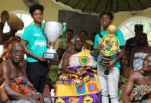 Grace Acheampong and Mavis Owusu with the trophy as the Asantehene look on
