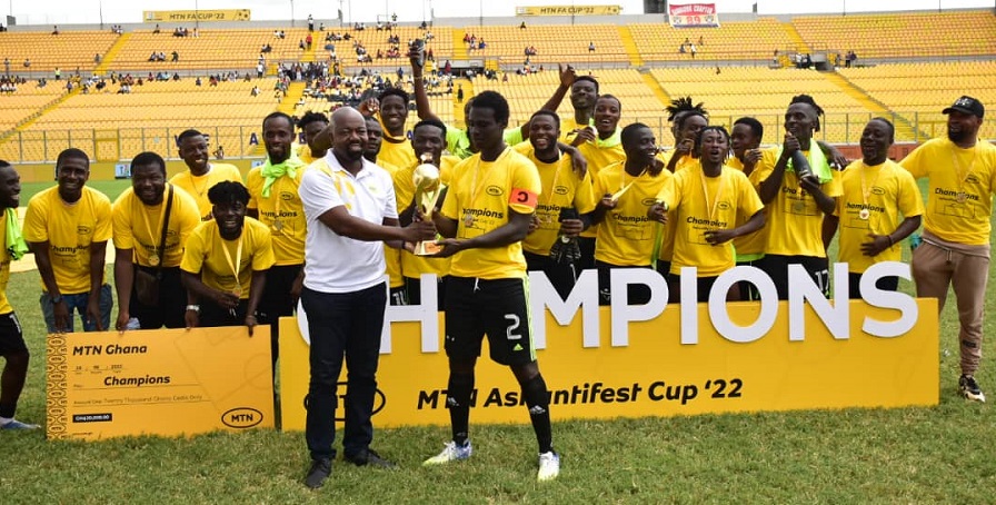 Mr Mingle (left) presents the trophy to the captain of Tafo